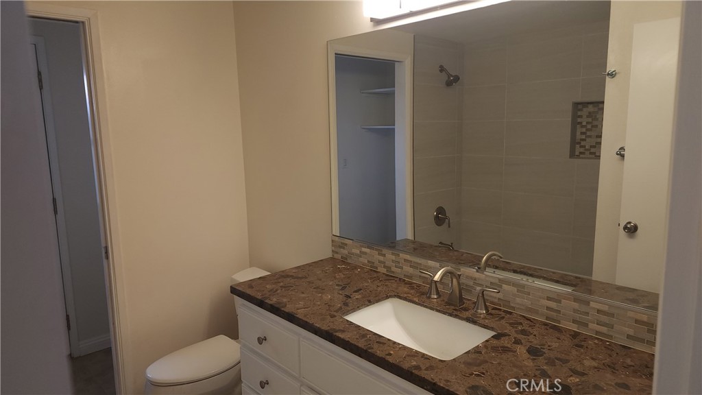 1617 Sunset Lane Fullerton, CA 92833 - Photo 12 of 18 a bathroom with a granite countertop sink and a mirror