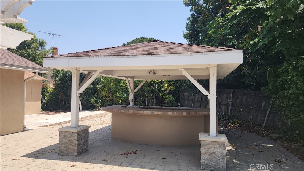 1617 Sunset Lane Fullerton, CA 92833 - Photo 16 of 18 a view of a patio with table and chairs and wooden fence