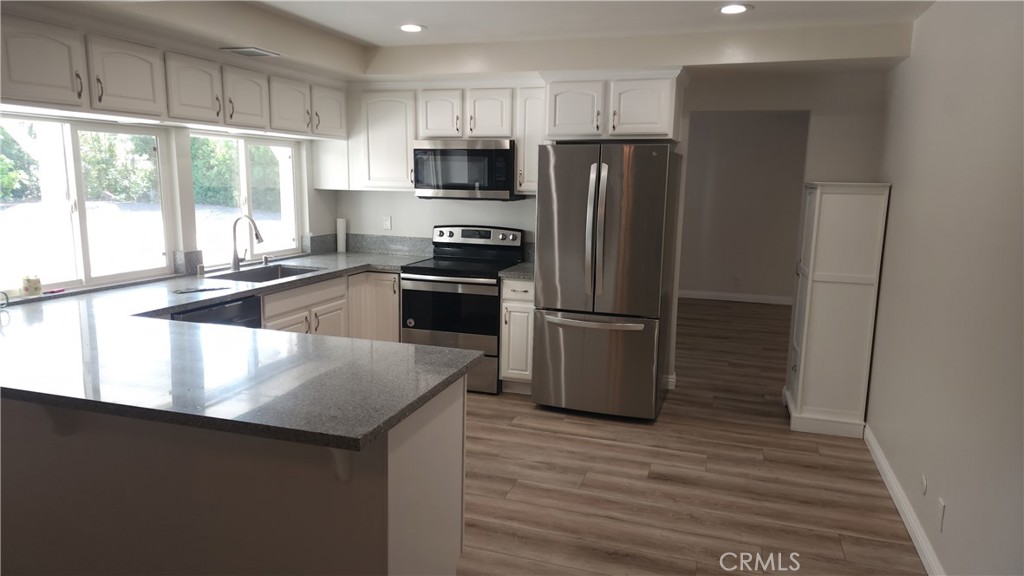 1617 Sunset Lane Fullerton, CA 92833 - Photo 4 of 18 a kitchen with granite countertop a refrigerator and a stove top oven
