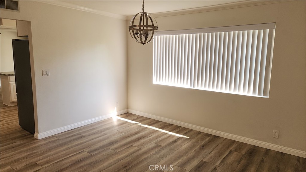 1617 Sunset Lane Fullerton, CA 92833 - Photo 6 of 18 a view of an empty room with wooden floor and a window