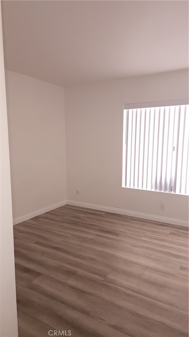 1617 Sunset Lane Fullerton, CA 92833 - Photo 9 of 18 a view of an empty room with wooden floor and a window