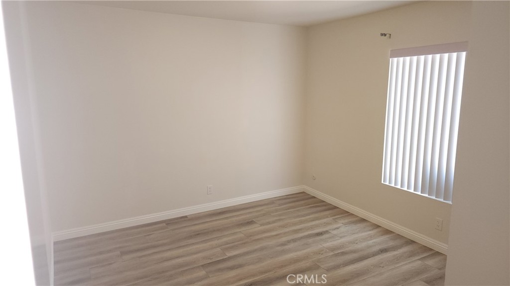 1617 Sunset Lane Fullerton, CA 92833 - Photo 10 of 18 an empty room with wooden floor and windows