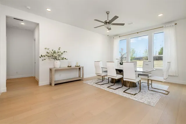 a large white kitchen with stainless steel appliances kitchen island granite countertop a sink and cabinets