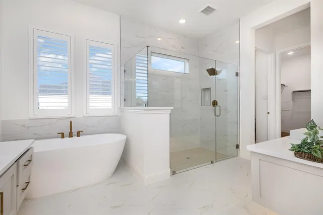 a bedroom with a bed chandelier and a window