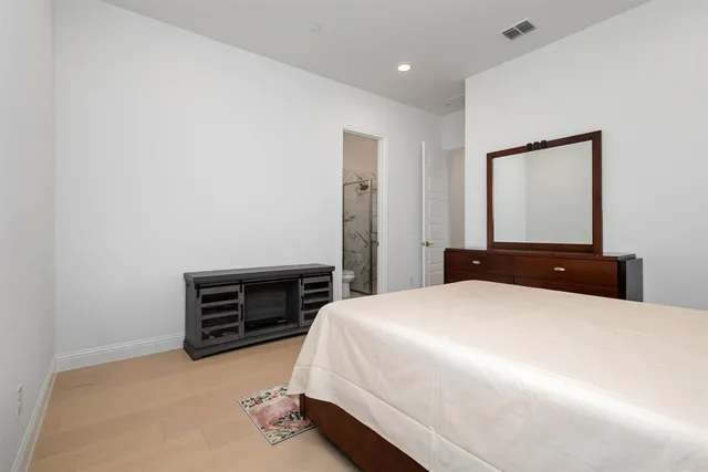 a bathroom with a double vanity sink window and mirror