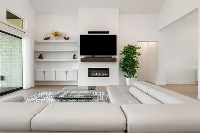 a living room with a flat screen tv and a fireplace