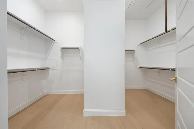 a view of walk in closet with empty racks