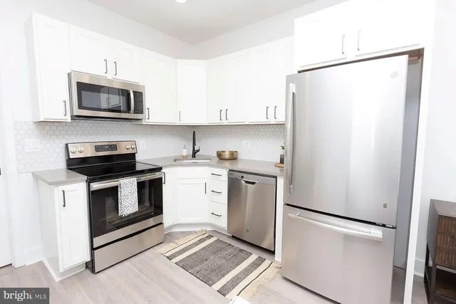 a kitchen with a refrigerator stove and microwave