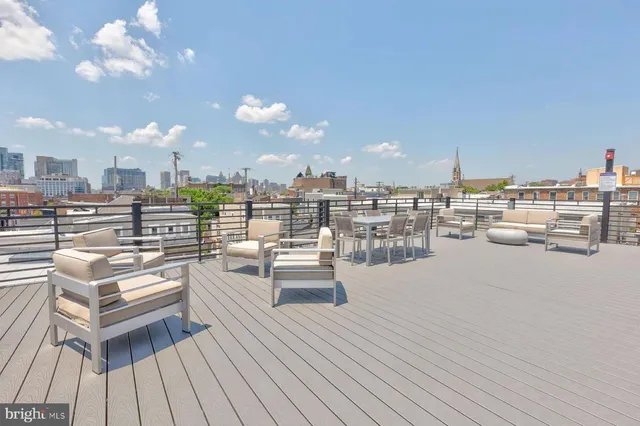 a view of a swimming pool with outdoor seating