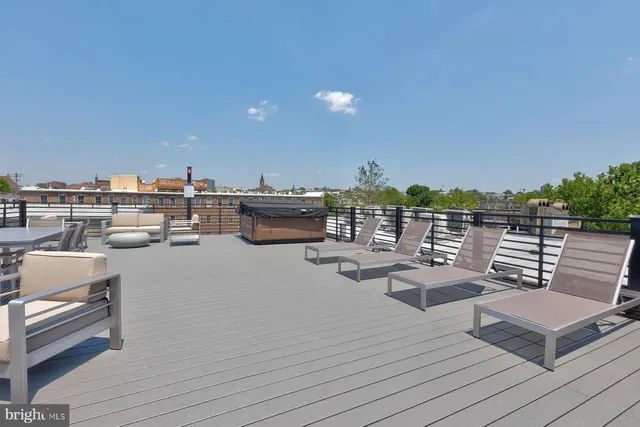 a view of a roof deck with wooden floor and seating space