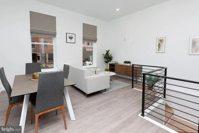a living room with furniture wooden floor and a window