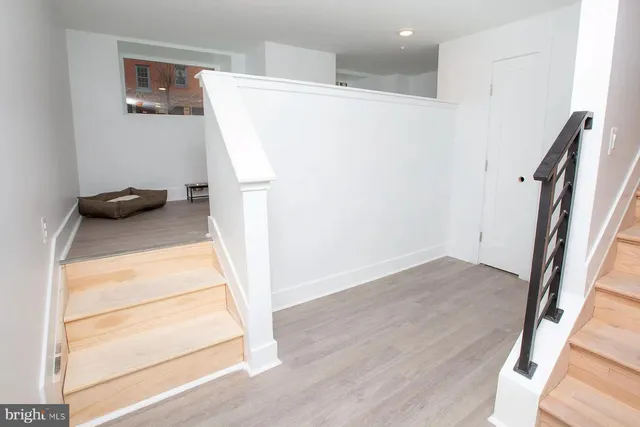 a view of entryway with wooden floor and stairs