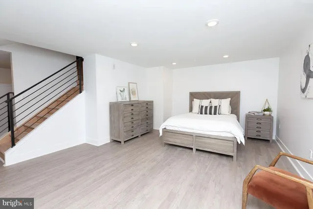 a spacious bedroom with a bed and a couch