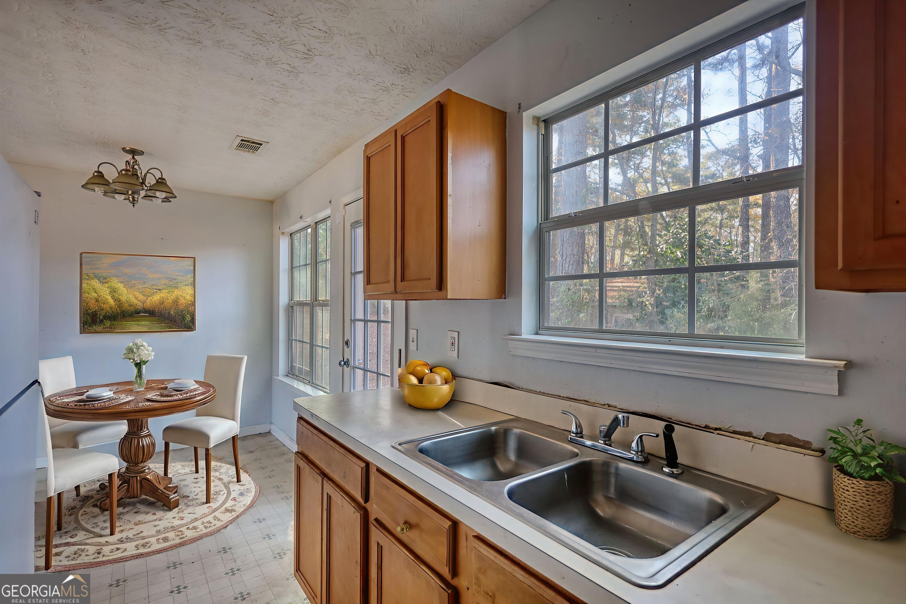 253 Nancy Street Monticello, GA 31064 - Photo 13 of 34 a kitchen with a sink cabinets and window