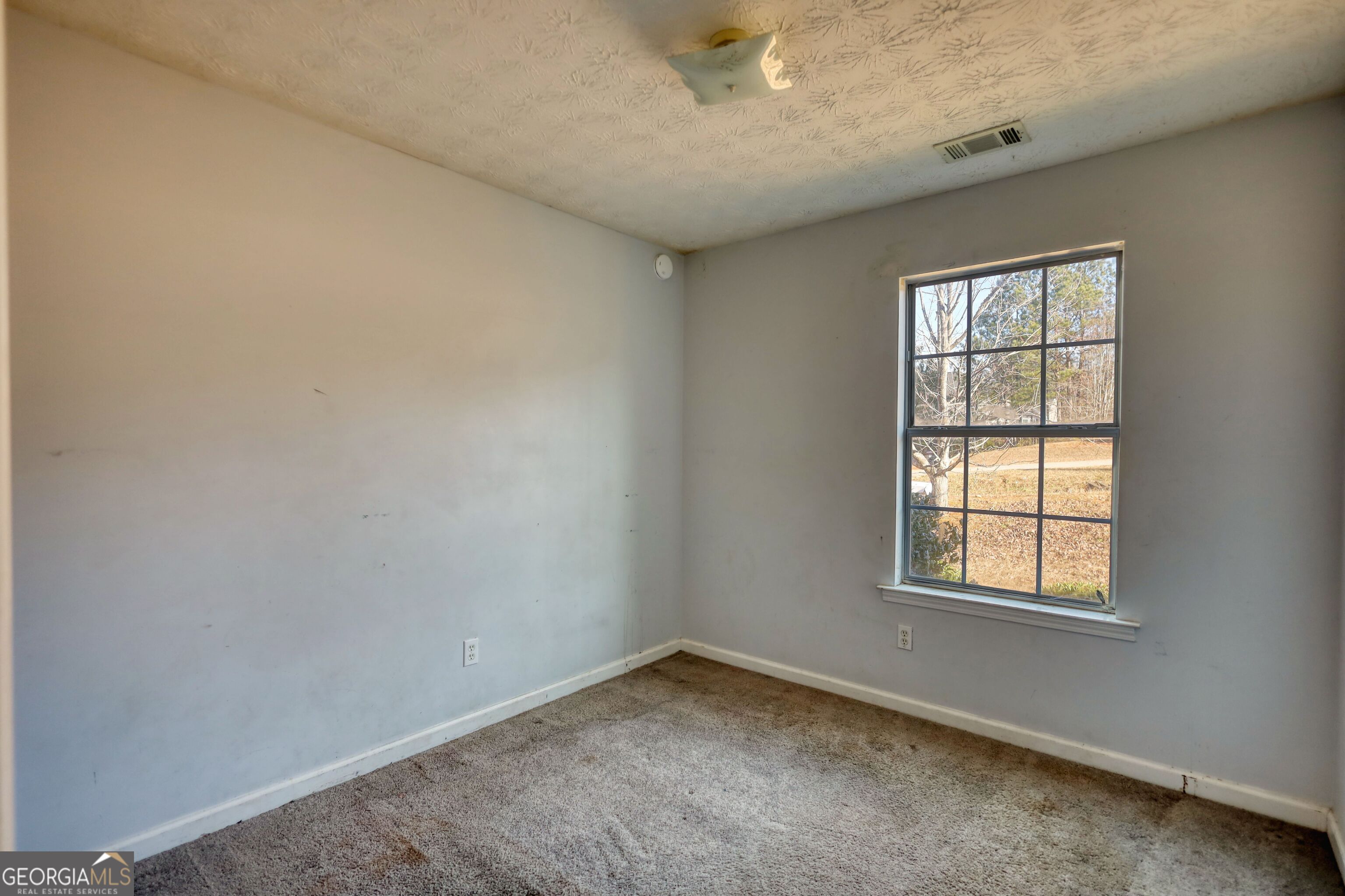 253 Nancy Street Monticello, GA 31064 - Photo 16 of 34 an empty room with a window