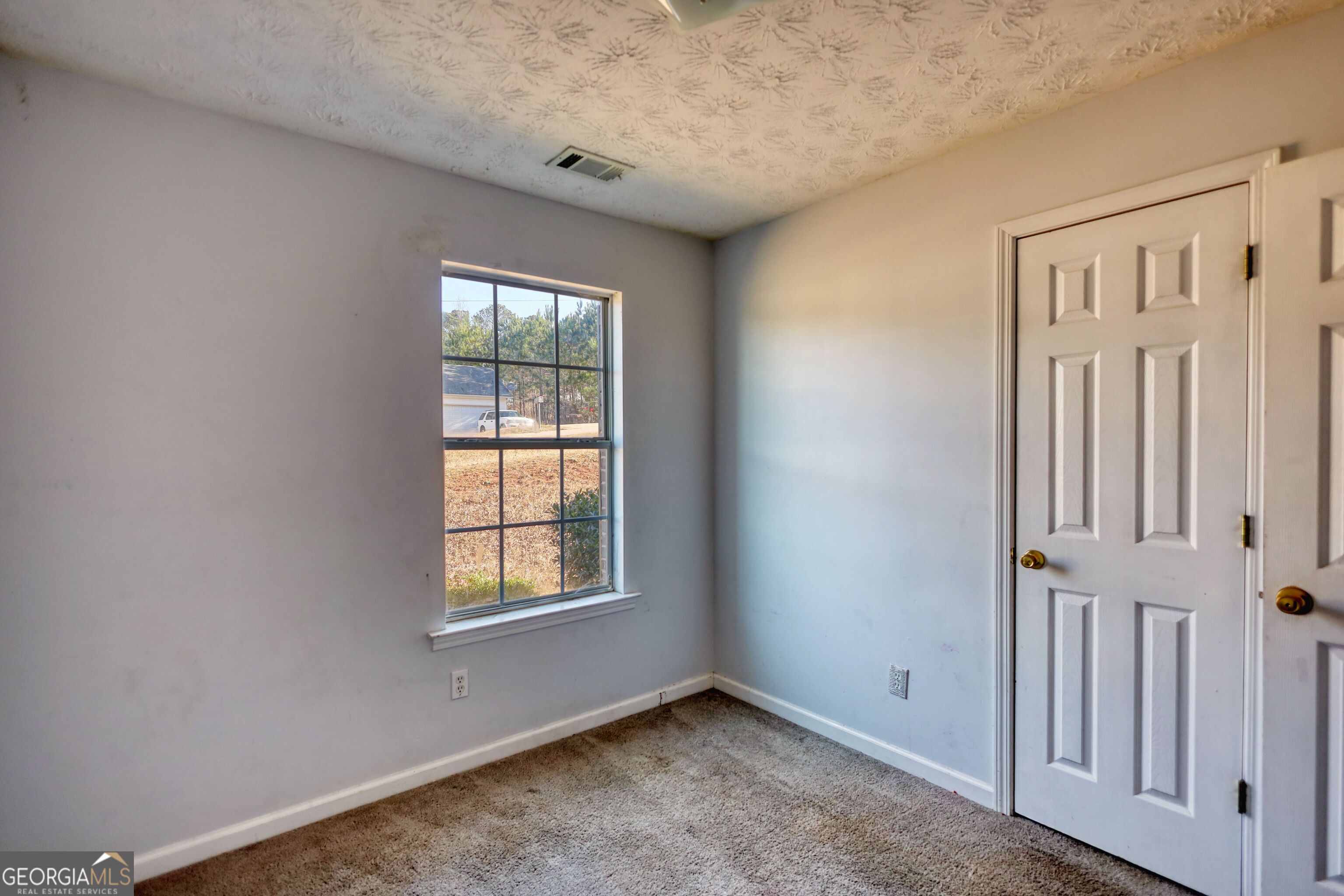 253 Nancy Street Monticello, GA 31064 - Photo 17 of 34 an empty room with windows