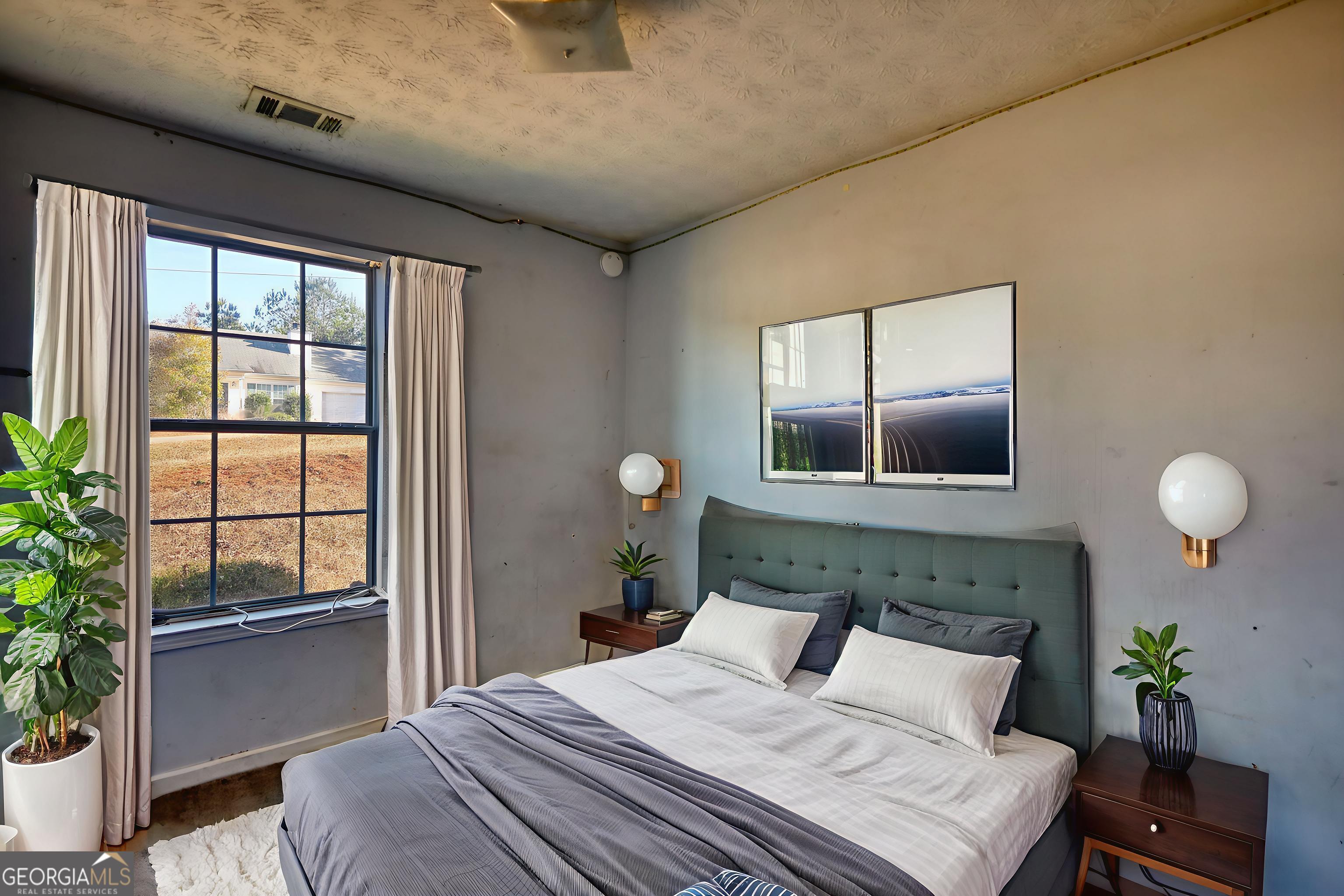 253 Nancy Street Monticello, GA 31064 - Photo 18 of 34 a bedroom with a bed and wooden floor