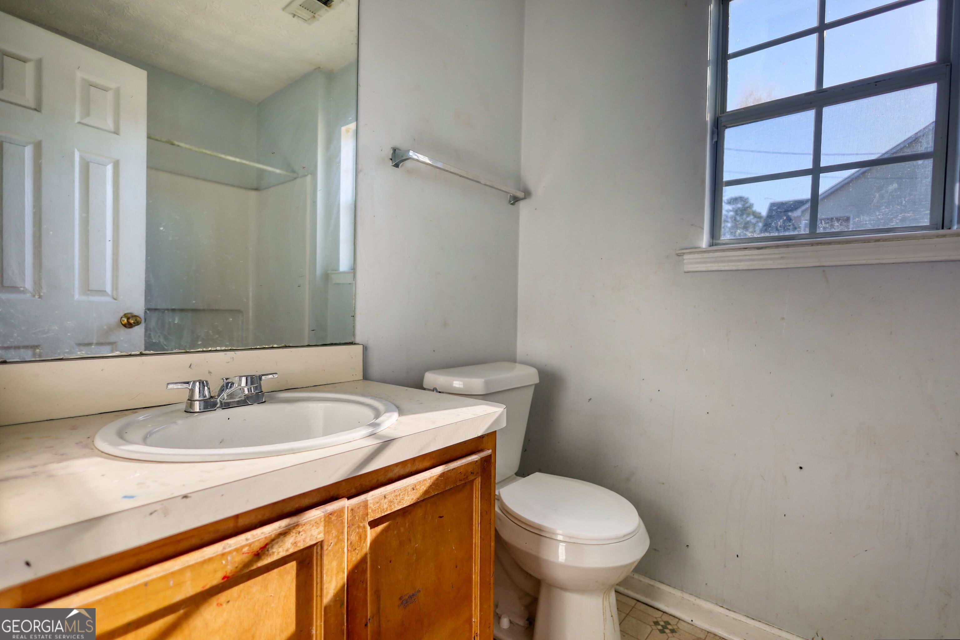 253 Nancy Street Monticello, GA 31064 - Photo 21 of 34 a bathroom with a toilet sink and mirror
