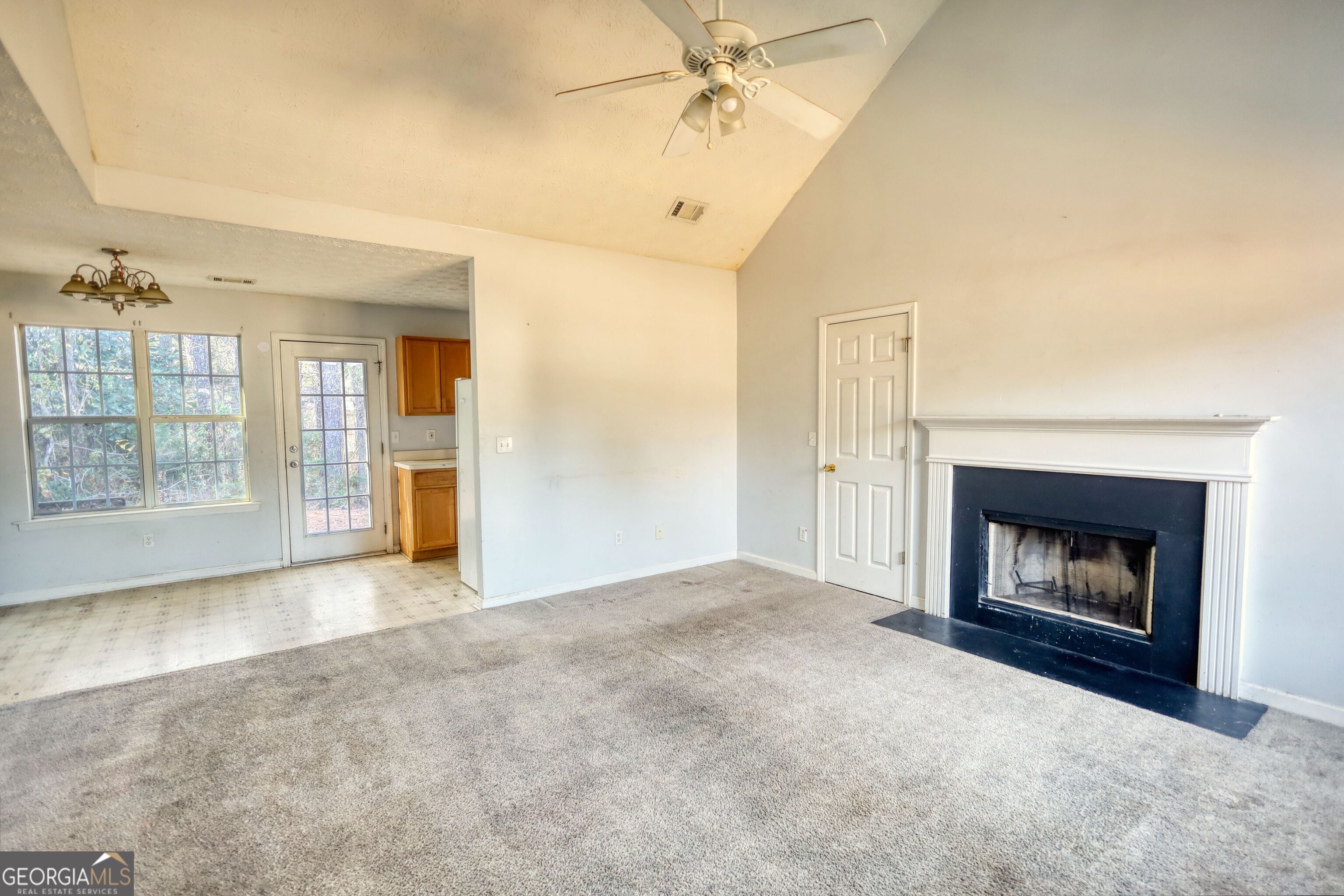 253 Nancy Street Monticello, GA 31064 - Photo 4 of 34 an empty room with windows and fireplace