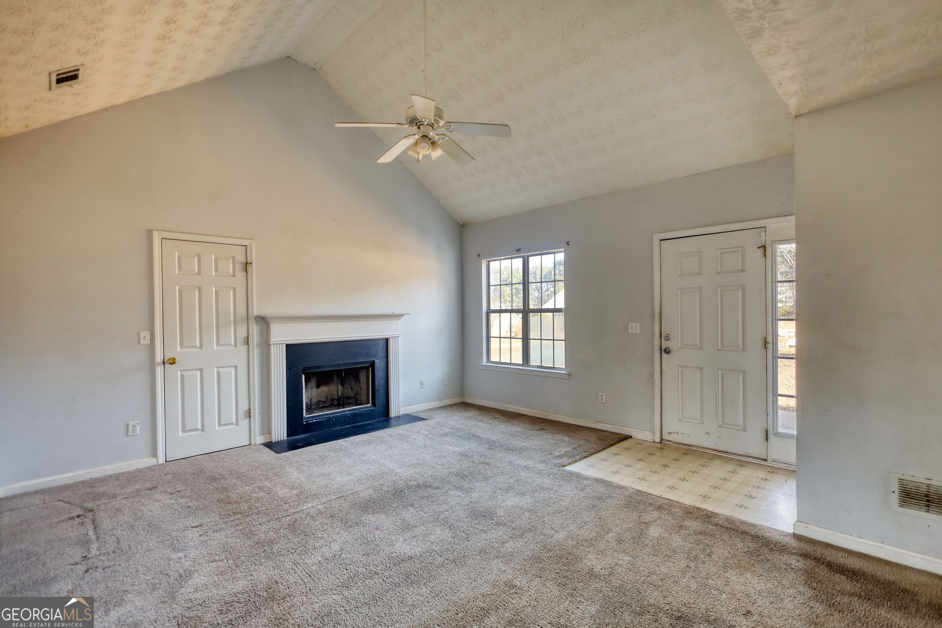 253 Nancy Street Monticello, GA 31064 - Photo 7 of 34 a view of a livingroom with a fireplace and chandelier fan
