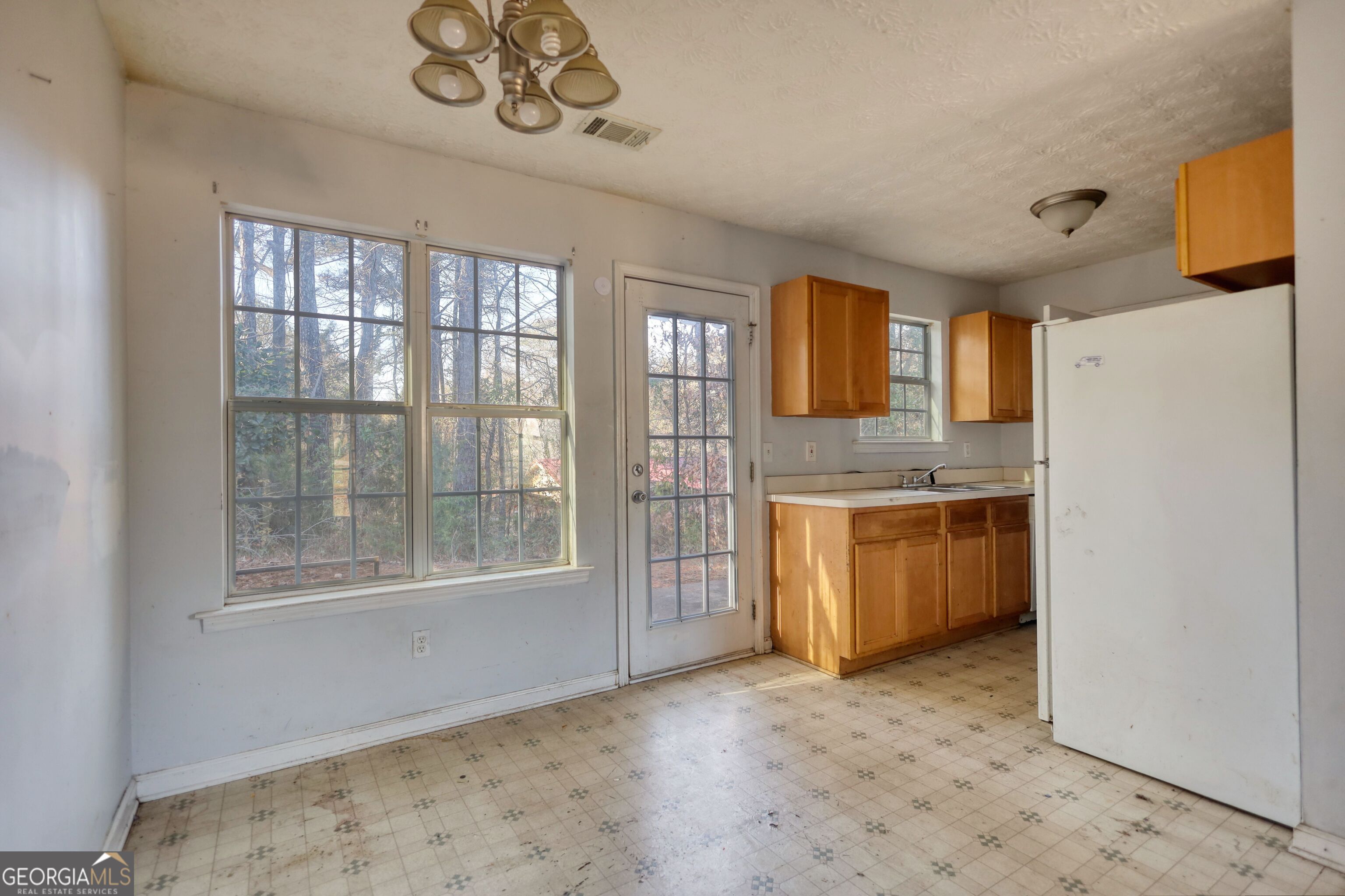 253 Nancy Street Monticello, GA 31064 - Photo 8 of 34 a view of a kitchen with a sink cabinet and a window