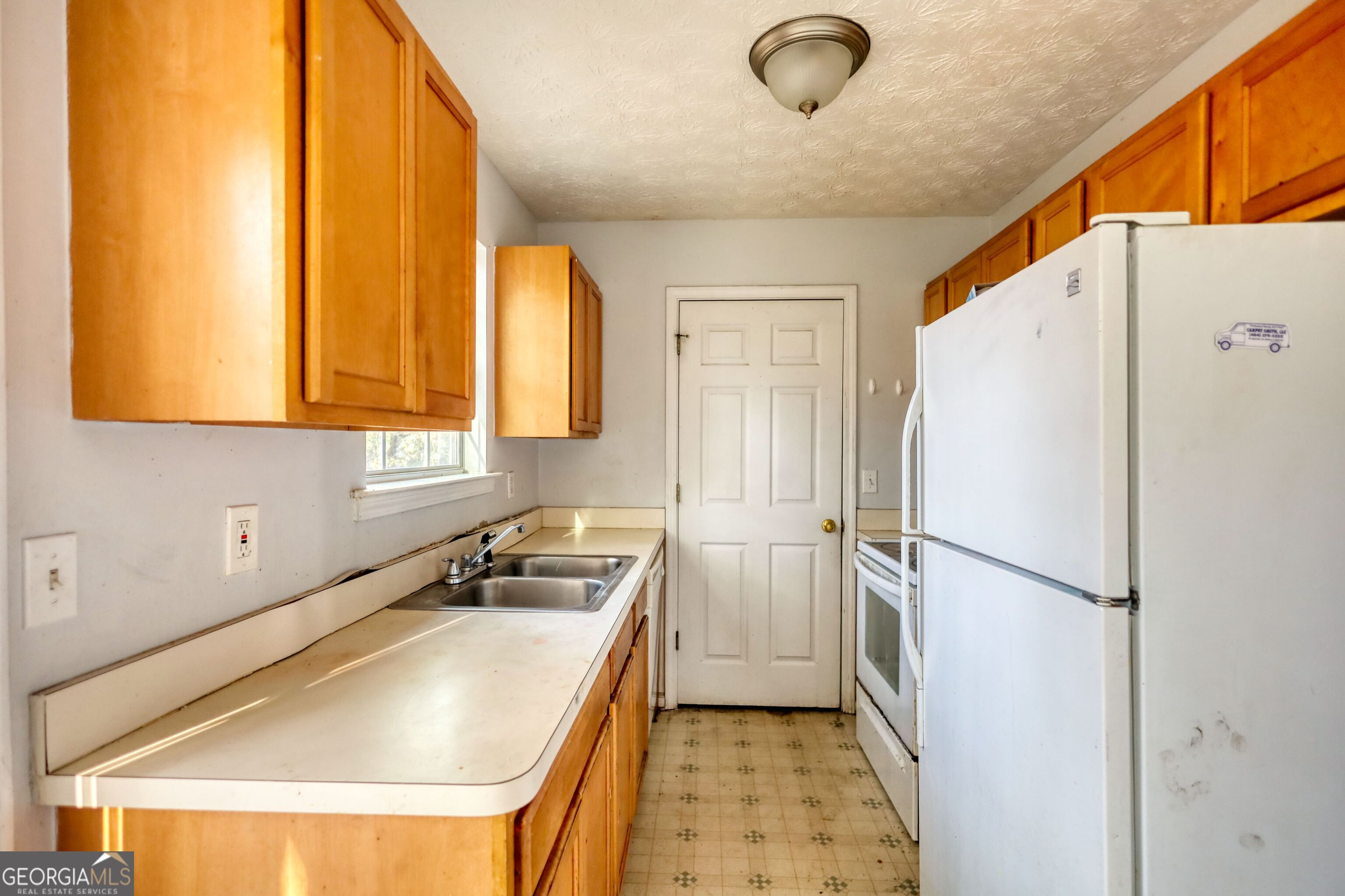 253 Nancy Street Monticello, GA 31064 - Photo 9 of 34 a white refrigerator freezer sitting in a kitchen