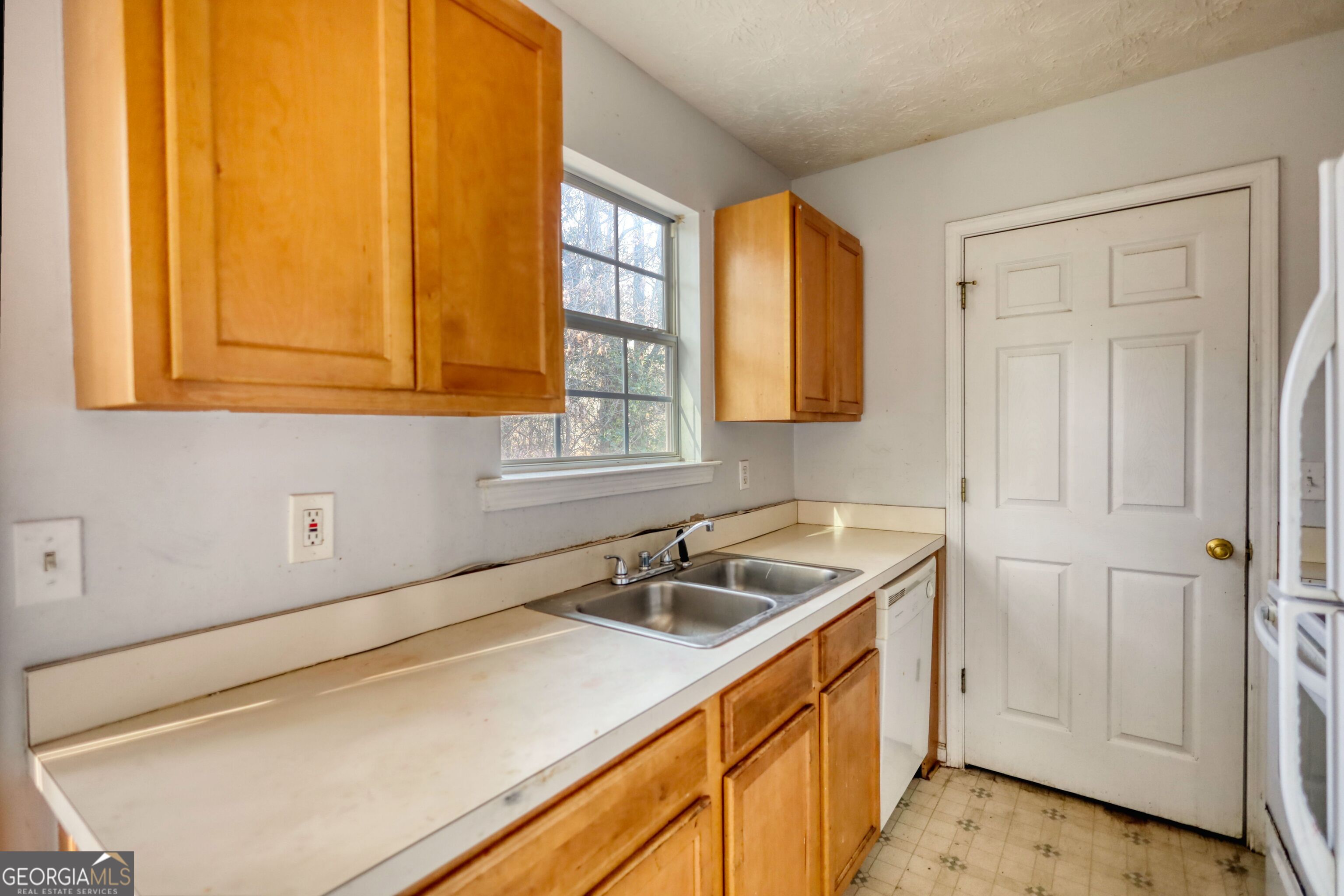 253 Nancy Street Monticello, GA 31064 - Photo 10 of 34 a kitchen with a sink and cabinets