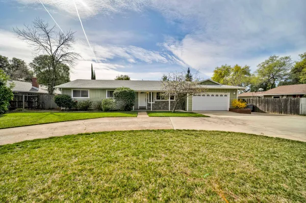 a front view of house with yard and green space
