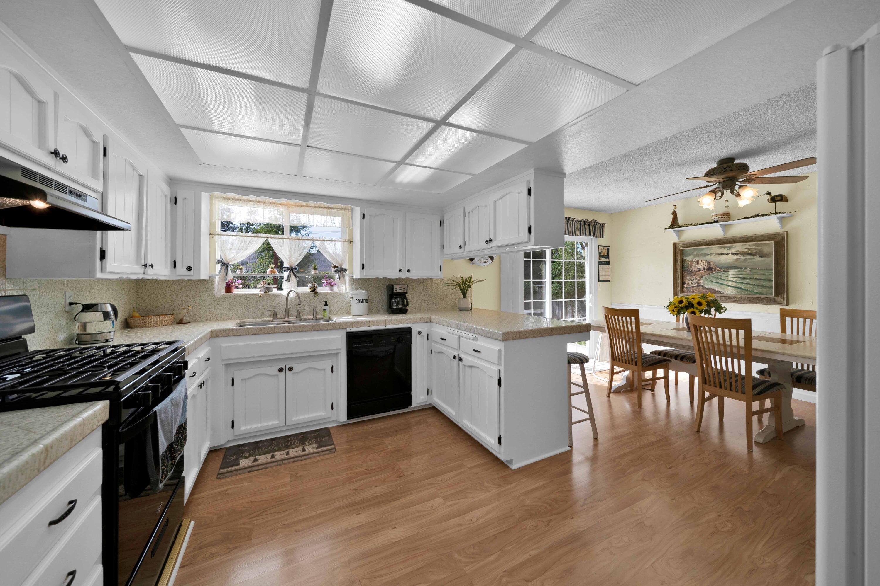 2195 Rancho Road Redding, CA 96002 - Photo 16 of 47 a kitchen with sink cabinets and dining table chairs