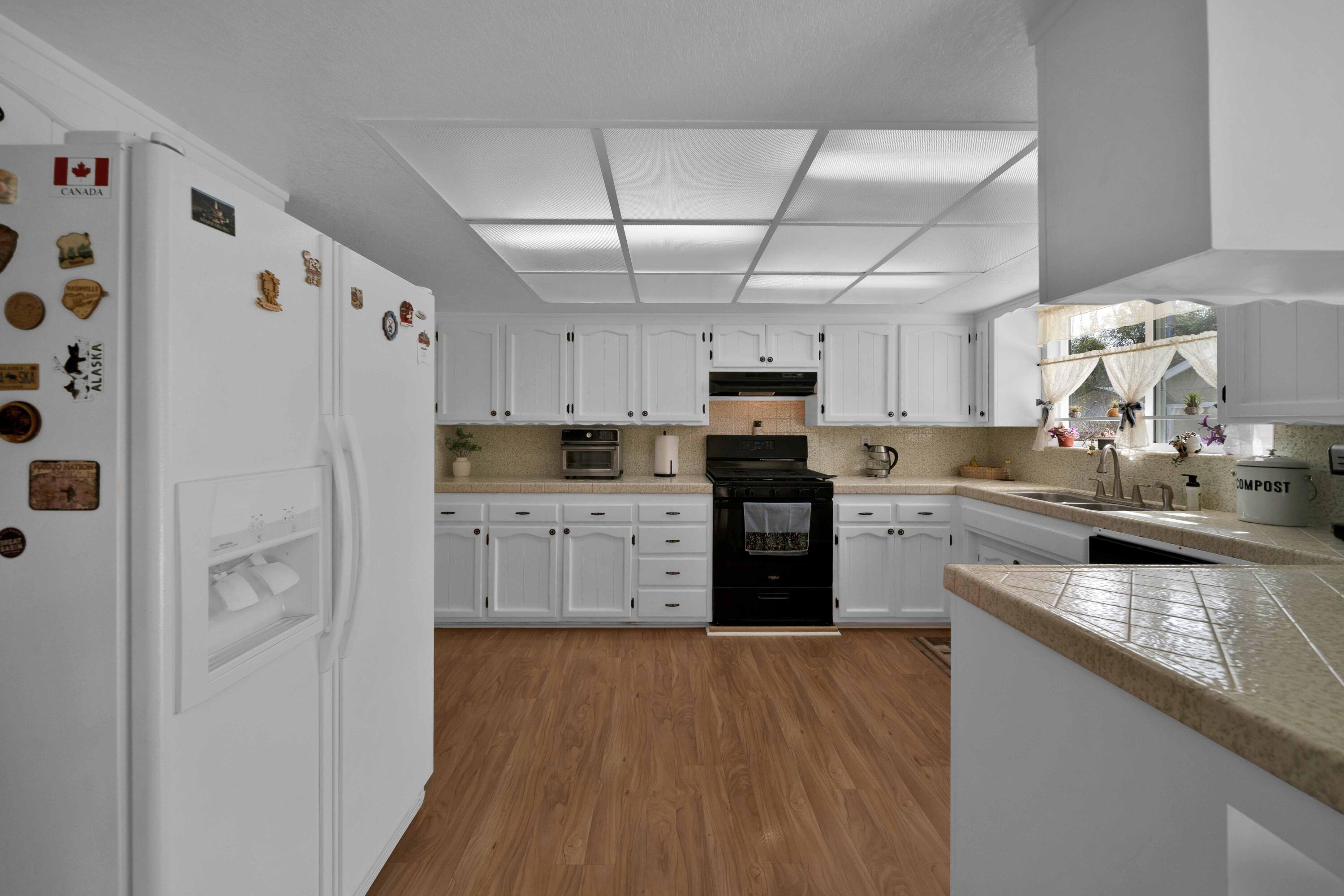 2195 Rancho Road Redding, CA 96002 - Photo 18 of 47 a kitchen with stainless steel appliances a refrigerator and a stove top oven