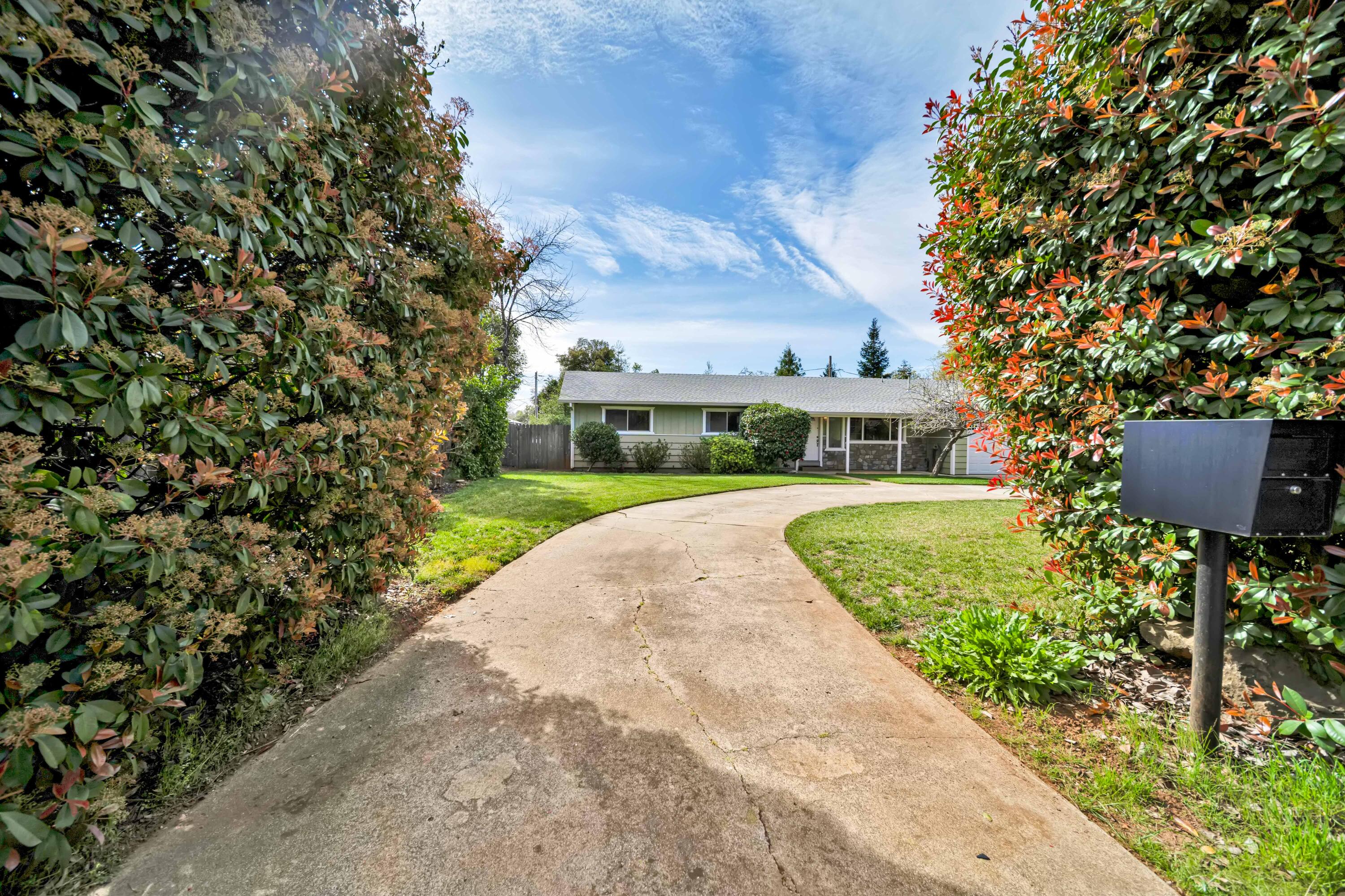 2195 Rancho Road Redding, CA 96002 - Photo 2 of 47 view of a house with a yard and potted plants