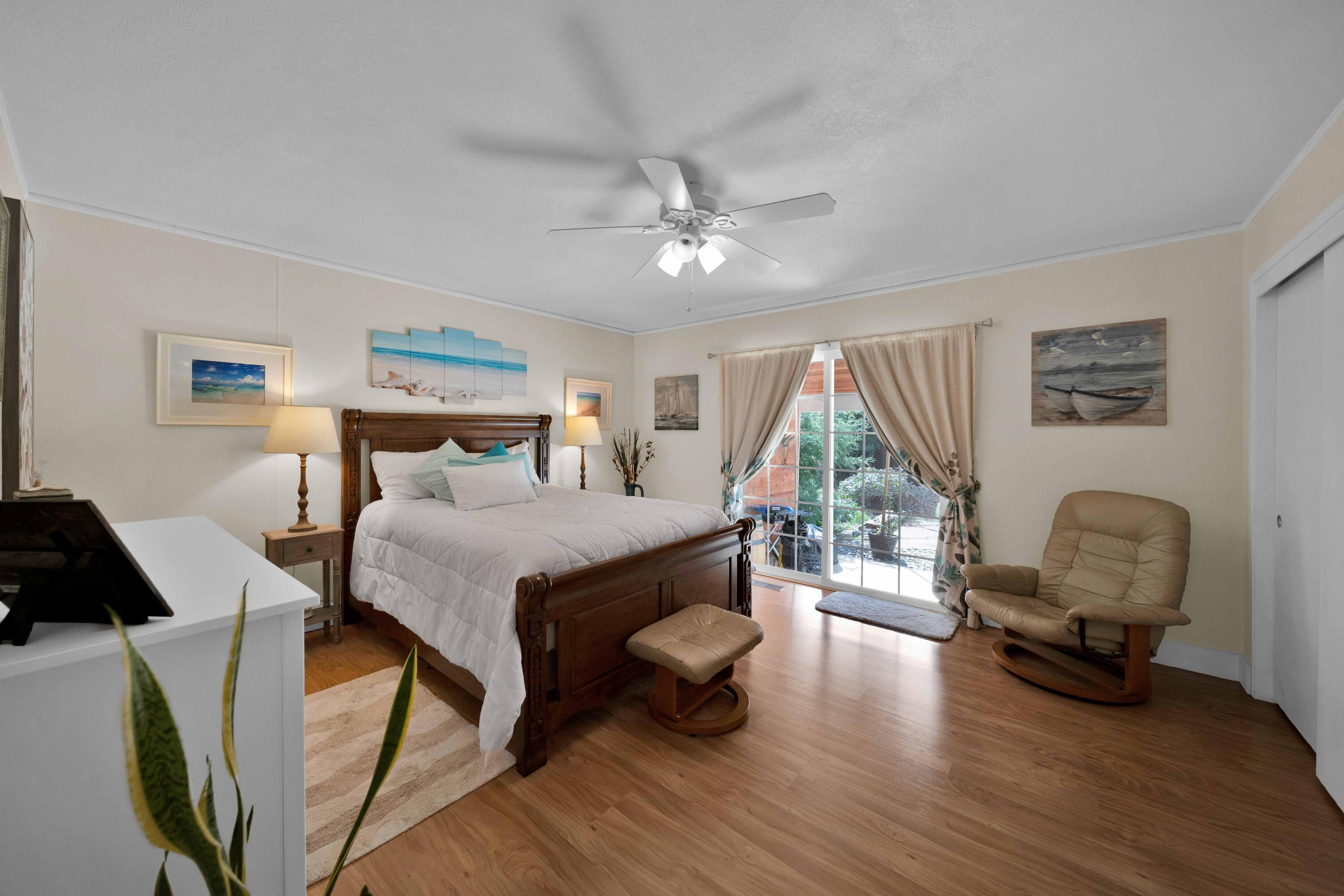 2195 Rancho Road Redding, CA 96002 - Photo 22 of 47 a bedroom with a bed a couch and a chandelier