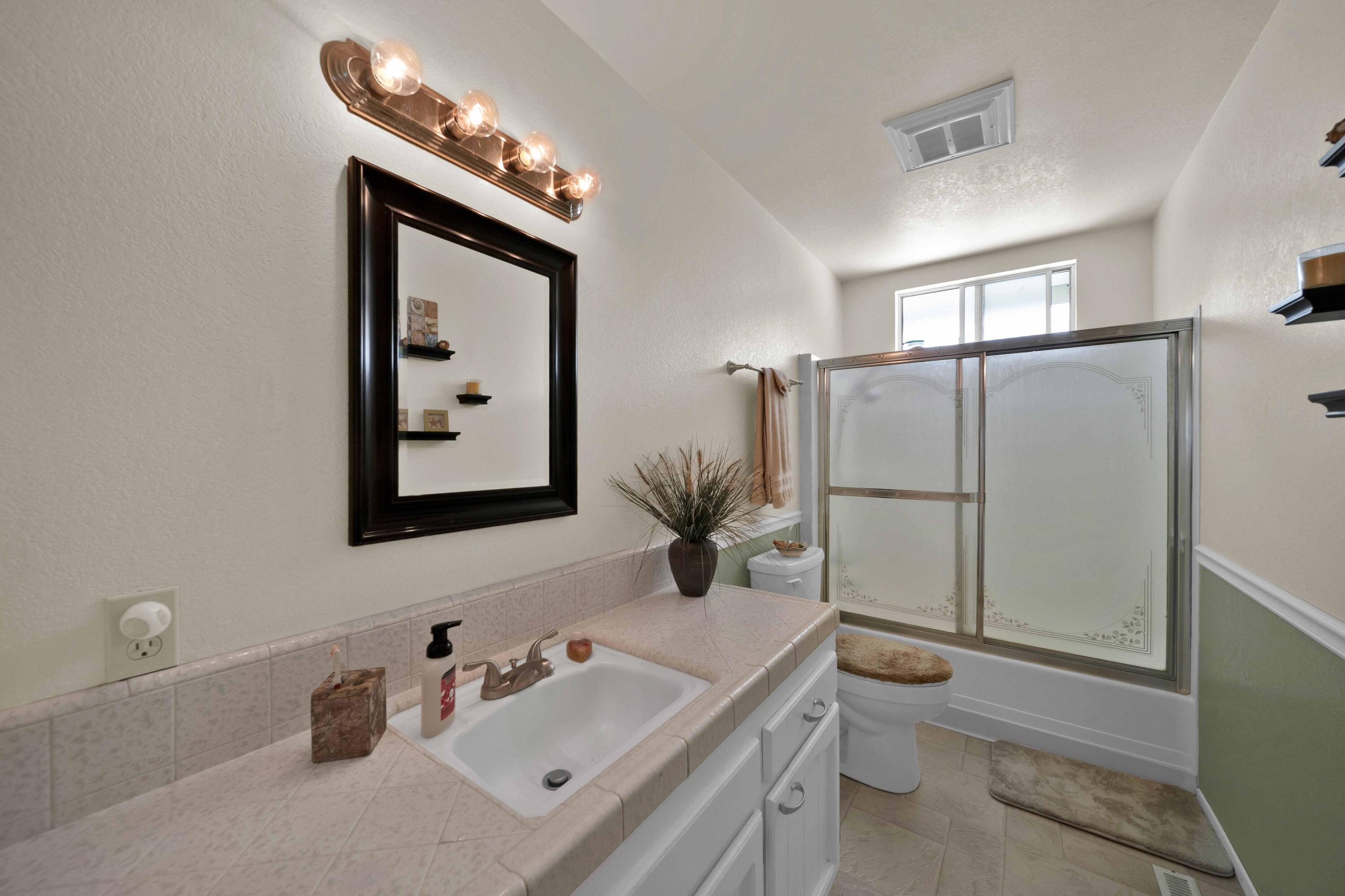 2195 Rancho Road Redding, CA 96002 - Photo 33 of 47 a bathroom with a sink mirror and toilet