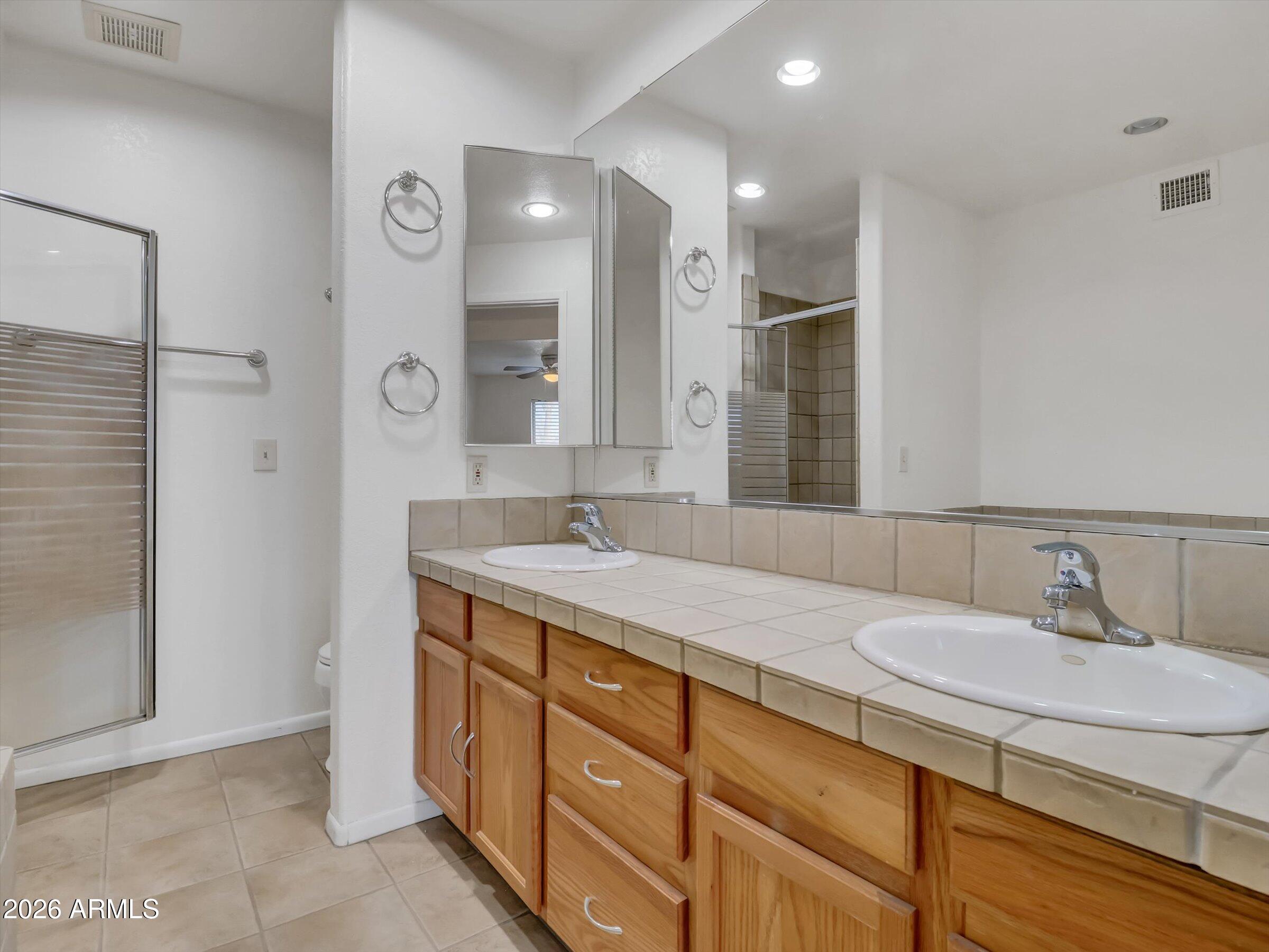 1705 East Grandview Road Phoenix, AZ 85022 - Photo 11 of 19 a bathroom with a sink double vanity and a shower