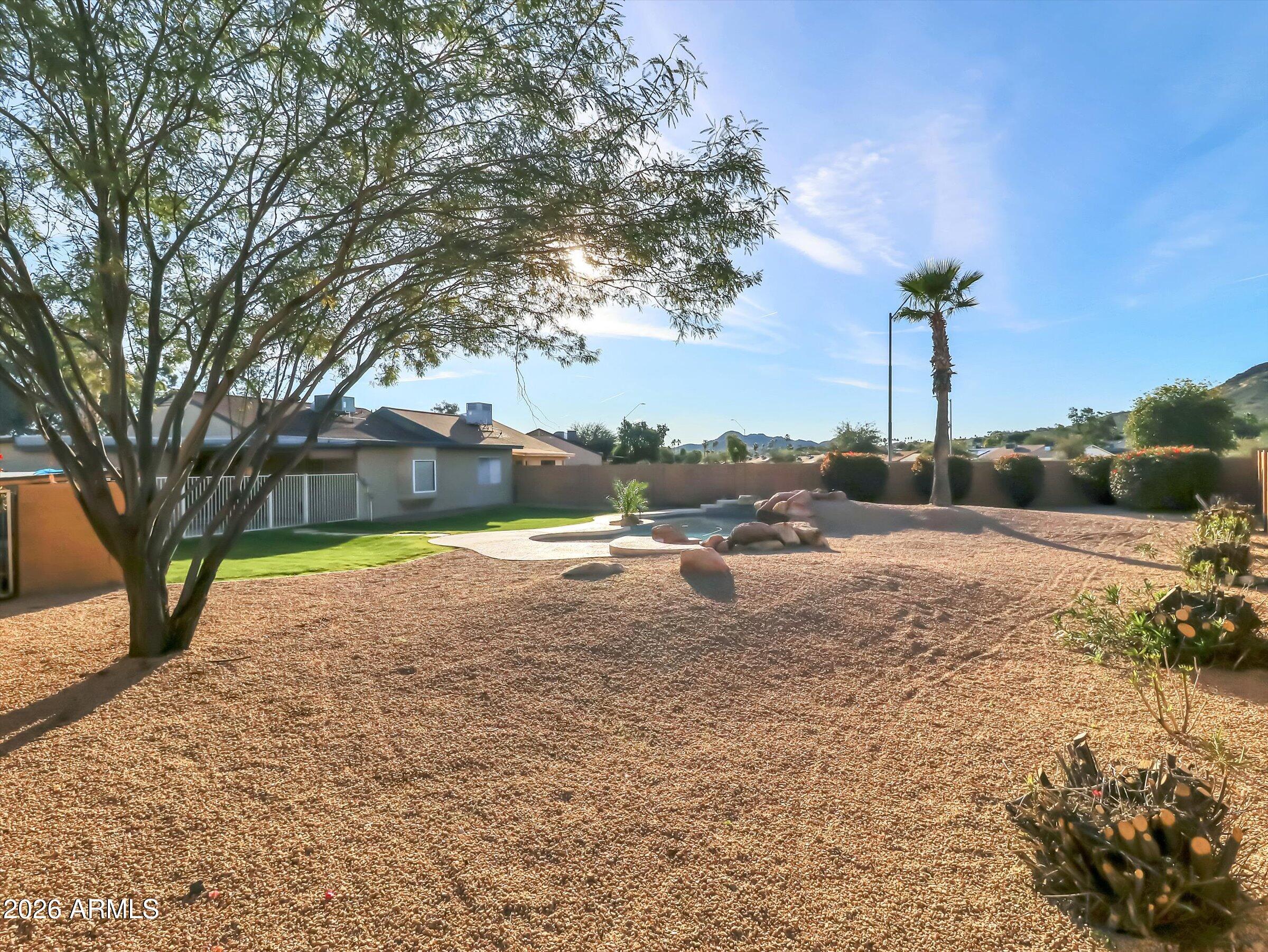 1705 East Grandview Road Phoenix, AZ 85022 - Photo 17 of 19 a view of a house with a yard and sitting area