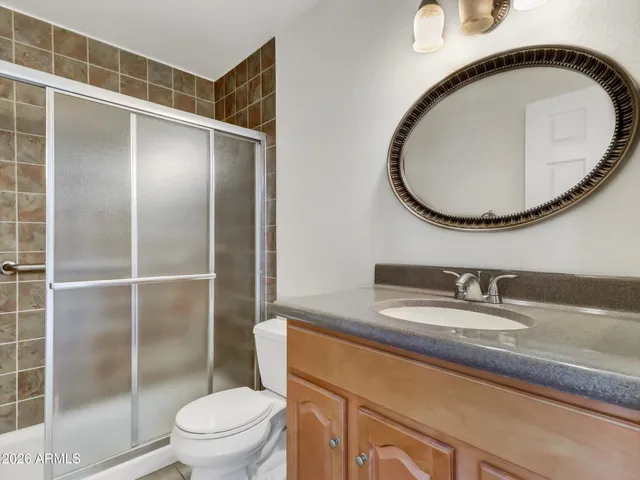 a bathroom with a sink a toilet and a mirror