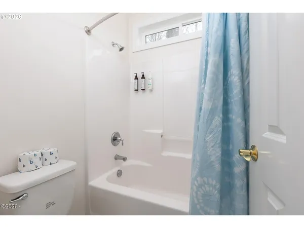 a bathroom with a bathtub sink and shower