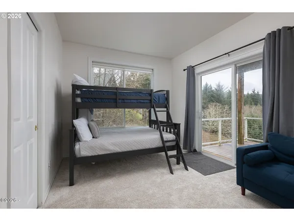a living room with furniture and a floor to ceiling window