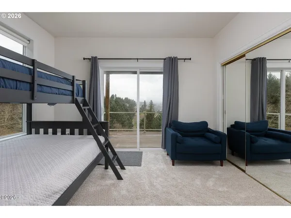 a bedroom with furniture and a large window