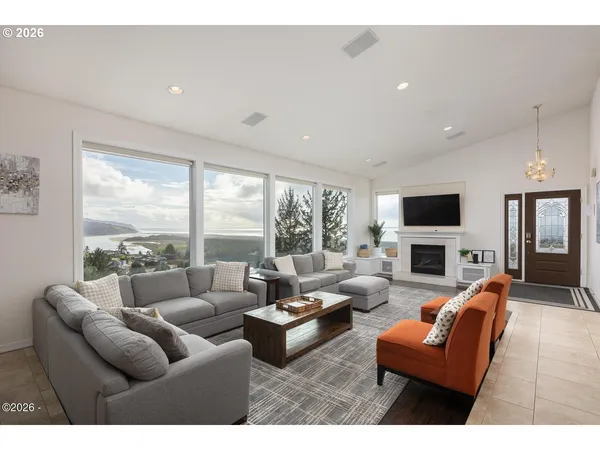 a living room with fireplace furniture and a flat screen tv