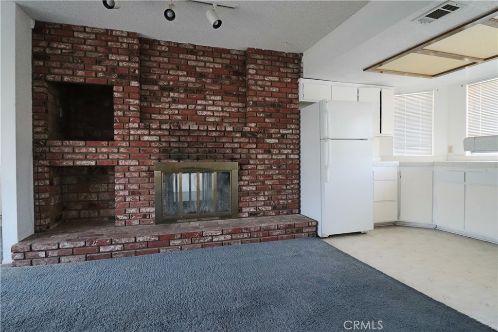 4752 Flying H Road Twentynine Palms, CA 92277 - Photo 28 of 55 a living room with fireplace