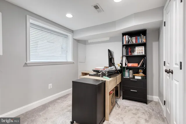 a view of a workspace with furniture and window