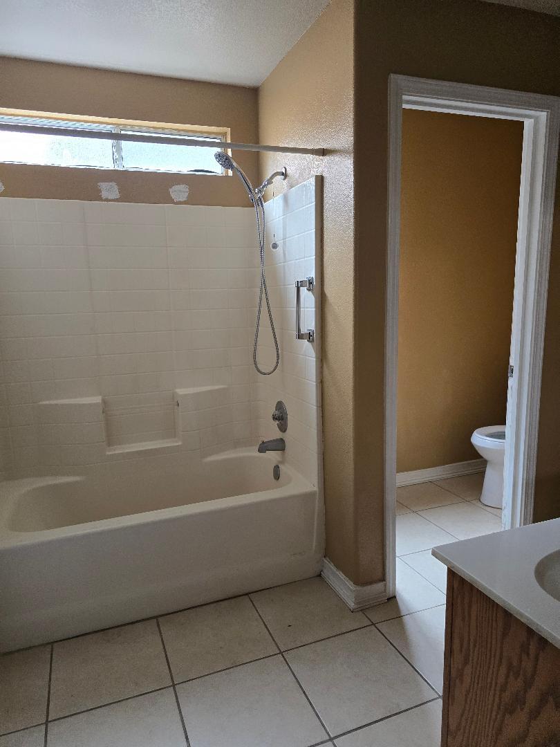 29124 Rio Verde Drive Gustine, CA 95322 - Photo 14 of 19 a bathroom with a bathtub and a shower