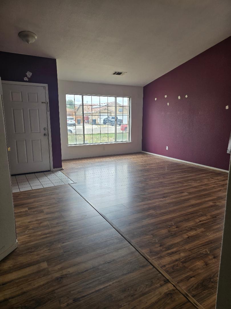 29124 Rio Verde Drive Gustine, CA 95322 - Photo 3 of 19 an empty room with wooden floor and windows