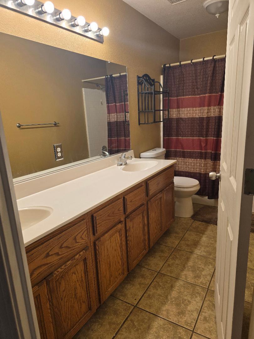29124 Rio Verde Drive Gustine, CA 95322 - Photo 8 of 19 a bathroom with a sink a toilet and shower