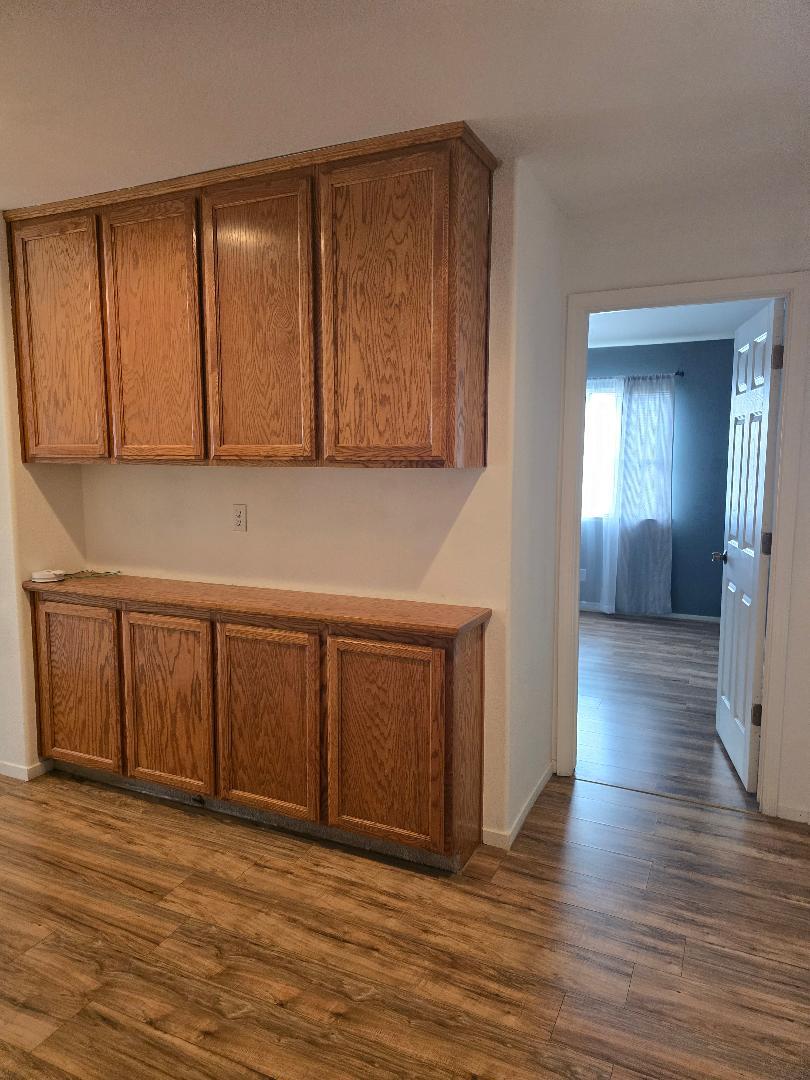 29124 Rio Verde Drive Gustine, CA 95322 - Photo 9 of 19 a view of an empty room with wooden floor and a cabinet