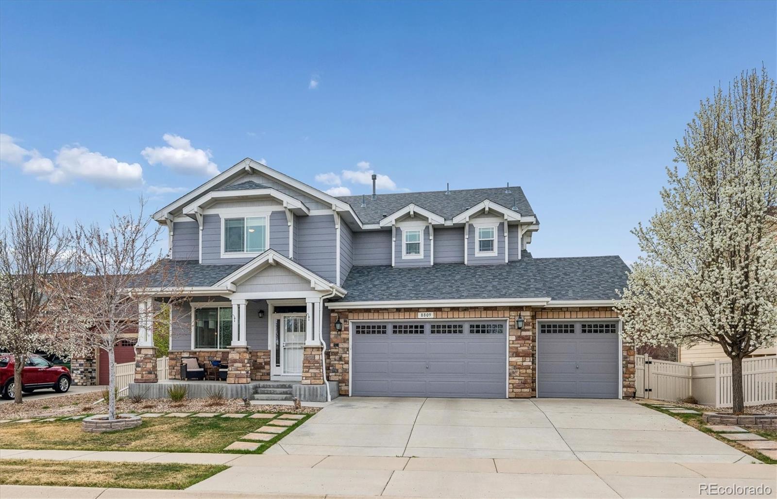 8809 Foxfire Street Firestone, CO 80504 - Photo 1 of 40 a front view of a house with a yard