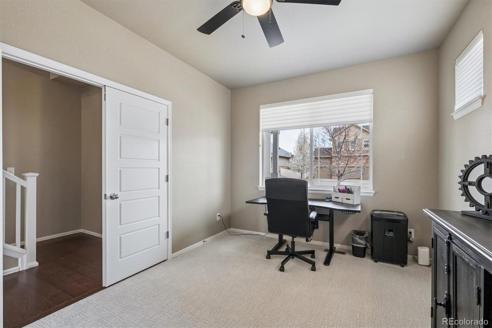 8809 Foxfire Street Firestone, CO 80504 - Photo 20 of 40 a view of a workspace with furniture and a window
