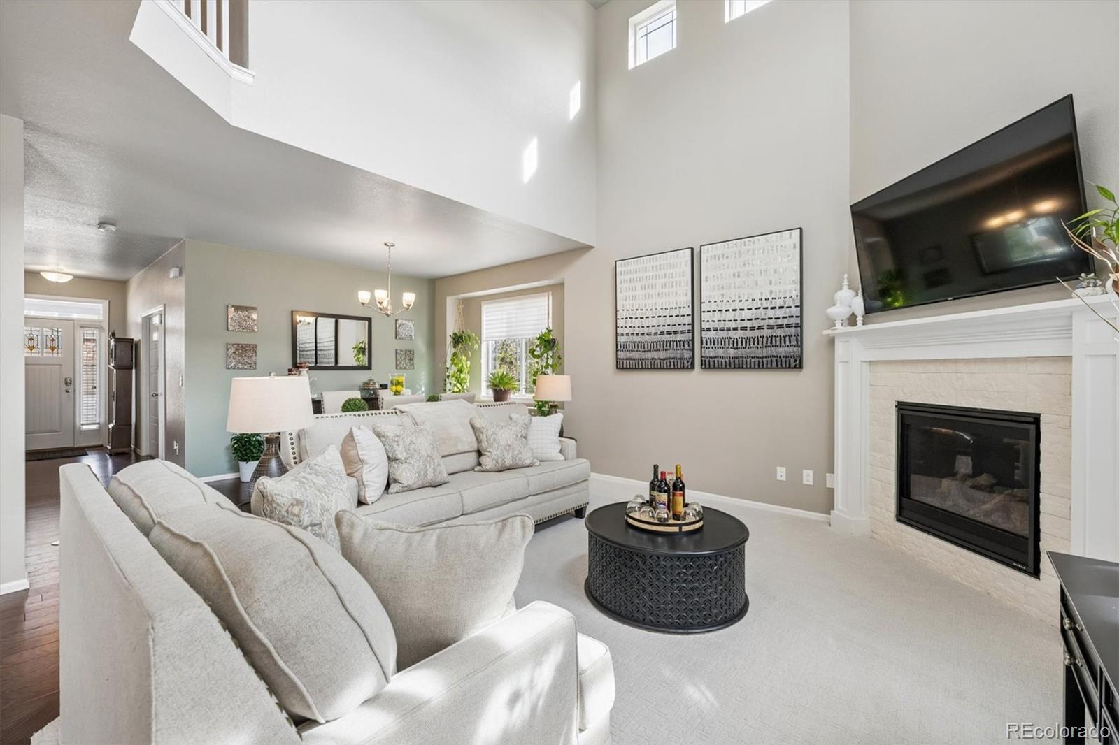 8809 Foxfire Street Firestone, CO 80504 - Photo 6 of 40 a living room with furniture a flat screen tv and a fireplace