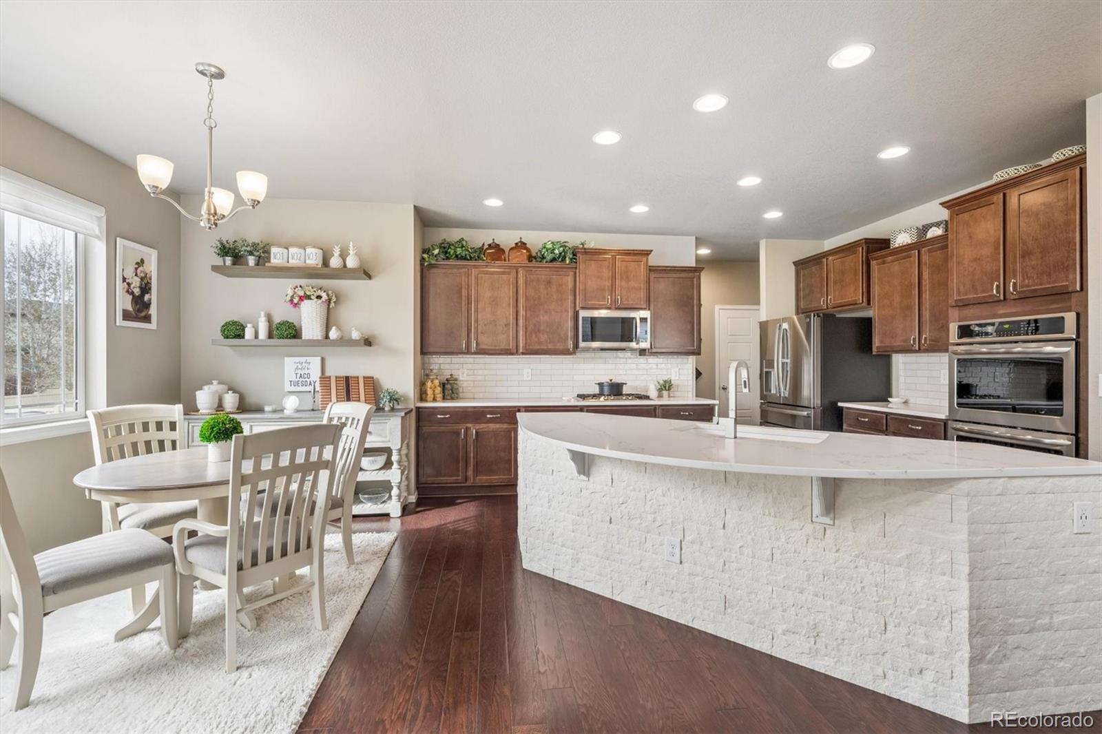 8809 Foxfire Street Firestone, CO 80504 - Photo 10 of 40 a large kitchen with a table and chairs